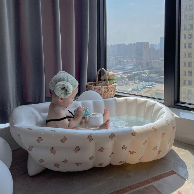 Bébé utilisant baignoire gonflable près fenêtre - Pratique et confortable pour appartement